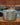 Stainless steel cookpot with lid on a wooden surface